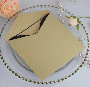 Elegant laser-cut kraft envelope with black and gold M+J monogram invitation card