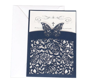 Detail of laser-cut navy blue butterfly and floral wedding invitation with inner card