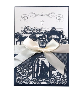 Detail of laser-cut carriage and floral design on navy blue wedding invitation card