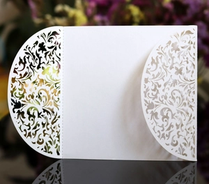 Detailed laser cut white card sleeve featuring intricate European style patterns