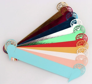 Macro view of laser-cut heart pattern napkin rings in ten vibrant pearlescent colors
