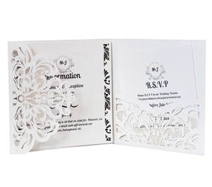 Elegant laser-cut ivory wedding invitation set with intricate lace pattern and RSVP card