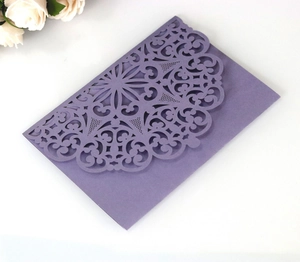 Detail of laser-cut hollow pattern on elegant lavender wedding invitation cover