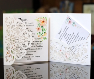Detail of laser-cut floral invitation card with pearlescent finish on mirror surface