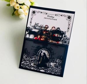 Detail of laser-cut wedding invitation featuring a blue carriage and floral design