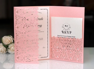Detail of laser-cut pink lace wedding invitation set with pearl paper texture and RSVP card