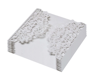 Detail of white laser-cut wedding invitations with elegant pearl paper floral patterns