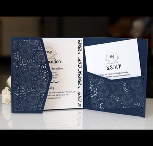 Detail of laser-cut sunflower pattern on dark blue wedding invitation with RSVP card