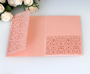 Detailed laser-cut lace floral pattern on pink pearlescent trifold wedding invitation