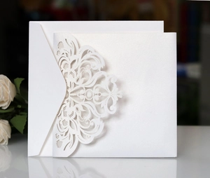 Detailed laser-cut floral wedding invitation card set with pearl white paper and envelope
