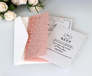 Pink laser-cut floral wedding invitation set with envelopes and RSVP cards