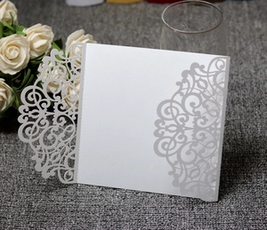 Laser-cut white wedding invitation cover with elegant baroque hollow patterns on paper