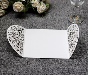 Detailed laser cut white floral hollow pattern on wedding invitation card cover
