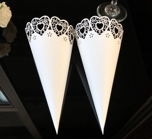 Detailed laser-cut white heart confetti cones for weddings with elegant lace pattern