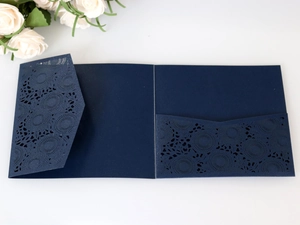 Detailed laser-cut floral patterns on dark blue square invitation card pocket