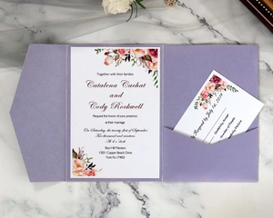 Detail of lavender pocket wedding invitation set with watercolor floral cards on marble