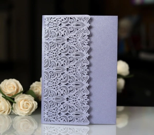 Detail of laser-cut lace pattern on pearlescent lavender wedding invitation card