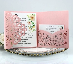 Detailed laser-cut pink wedding invitation card with intricate hollow floral patterns