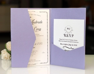 Macro detail of lavender purple pocket wedding invitation with elegant script and RSVP card