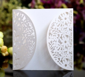 Close-up of laser cut hollow floral wedding invitation card cover in elegant white paper