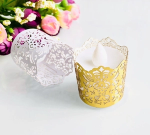 Laser-cut paper tea light holder with intricate vine patterns for LED candles