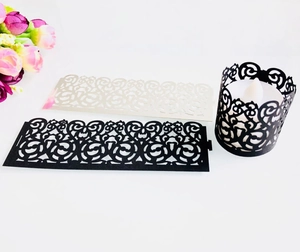 Detailed laser cut tea light wrappers in black and white pearlescent paper for party decor