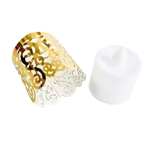 Detail of laser-cut gold hollow pattern lampshade with white LED tea light candle