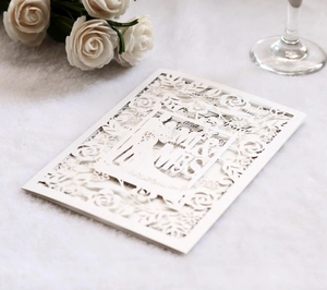 Macro view of white laser-cut wedding invitation featuring Mr & Mrs on faux fur