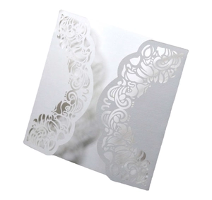 Elegant laser-cut white wedding invitation cover with intricate hollow floral patterns