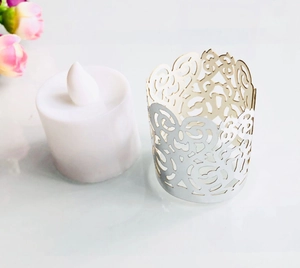 Detailed view of laser-cut hollow tea light wrap with white LED electronic candle