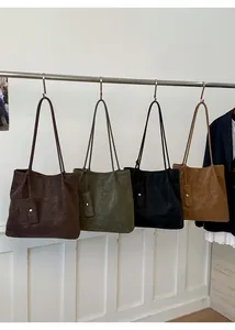Detailed view of large tote bags in coffee, green, black and tan with small pouches