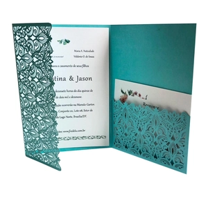 Intricate laser-cut teal wedding invitation sleeve with elegant lace flower patterns