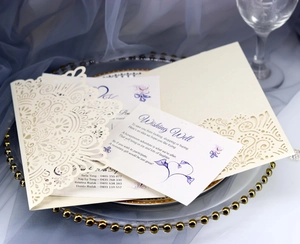 Detail of laser-cut wedding invitation set with purple floral print on matte paper card