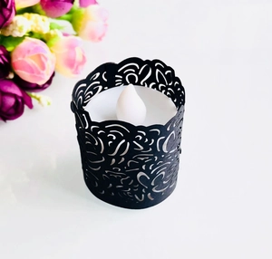 Detailed laser-cut black paper lace wrap with white LED tea light for festive decoration