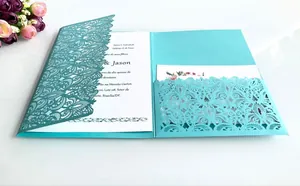 Detail of laser-cut tiffany blue wedding invitation with elegant hollow floral pattern