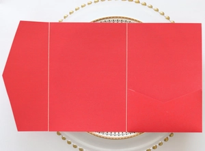 Detailed view of red tri-fold kraft paper invitation card with diagonal inner pocket