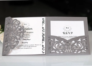 Detailed laser cut dark grey wedding invitation with white insert cards and RSVP text
