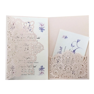 Detailed macro view of laser-cut mandala patterns on light pink wedding invitations