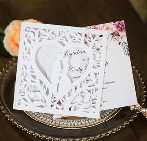 Laser cut heart wedding invitation with romantic silhouette on elegant gold trim plate