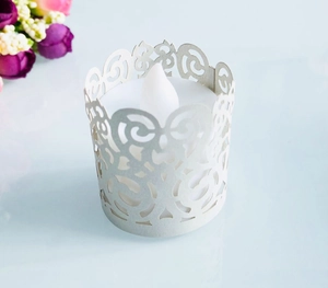 Detailed laser-cut vine pattern on cream paper tea light cover with white LED candle light