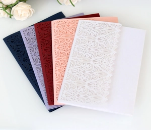 Detailed laser-cut lace floral patterns on elegant pearlescent wedding invitation covers