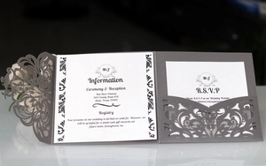 Detail of laser-cut floral wedding invitation set with RSVP card and grey envelope