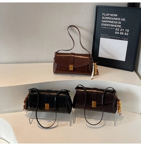 Three retro faux leather crossbody bags in brown, black, and burgundy with beaded charms
