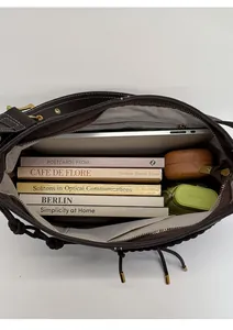 Spacious interior of dark brown vintage tote showing laptop and books storage