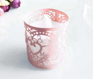 Detailed laser-cut pink paper candle wrap with heart patterns for LED tea lights