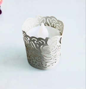 Detail of LED tea light candle with silver hollow carved floral pattern lampshade