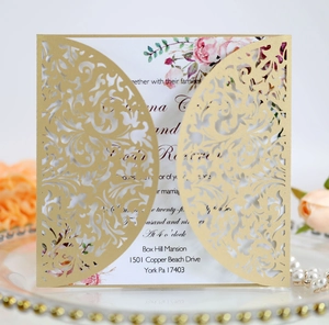 Detailed laser cut gold wedding invitation featuring intricate floral patterns and elegant inserts