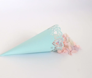 Detail of light blue laser-cut wedding petal cone with heart hollow lace patterns