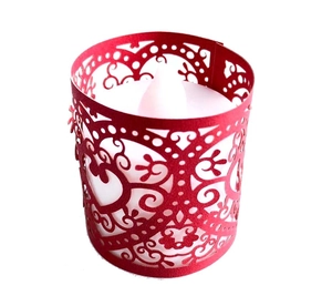 Detail of red hollow heart paper lampshade with a white LED flameless tea light inside