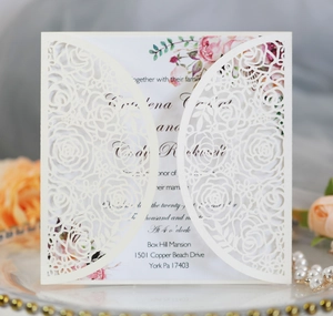 Close-up of laser-cut rose hollow invitation with watercolor floral inner card